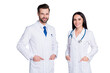 © deagreez - Photo of handsome doc guy practitioner experienced professional pretty lady two people patients consultation virology clinic good mood wear lab coats isolated grey color background