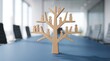 © CaptureCollabStudios - Wooden tree with human figures on branches on conference table representing corporate organization structure and company growth