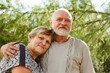 © Irina Bo/Stocksy - Two people are hugging in a sunny garden.