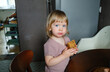 © Anna Artemenko/Stocksy - Young child holding a piece of homemade cake at home