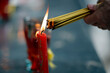 © robertharding - Incense is lit using a burning red candle during a religious ceremony at Ba Thien Hau Temple. Ho Chi Minh city. Vietnam.