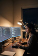 © Pablicus - Software developer coding at night with two monitors