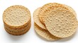 © miss irine - Stack of thin round crispy crackers isolated on white background. Pile of crunchy baked snacks with bumpy texture. Savoury wheat wafers papadum pieces for appetizer. Tasty light food items for