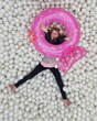 © Kaat Zoetekouw/Stocksy - Happy girl in ball pit