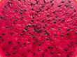 © Zeelia - Red dragon fruit flesh macro texture with black seeds