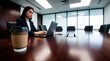 © Viktor - Paper coffee cup sits on wooden conference table in modern office. Pro businesswoman works on laptop computer in blurred background. Female executive manages tasks during morning break at corporate