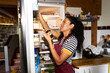 © Alvaro Lavin/Stocksy - Woman organizing food jars in kitchen refrigerator