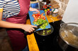 © Alvaro Lavin/Stocksy - Person cooking bell peppers in a kitchen