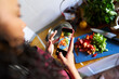 © Alvaro Lavin/Stocksy - Woman creating food content for social media with smartphone