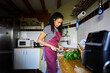 © Alvaro Lavin/Stocksy - Woman cooking healthy meal in home kitchen