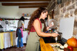 © Alvaro Lavin/Stocksy - Women cooking meal together in rustic kitchen