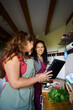 © Alvaro Lavin/Stocksy - Women friends cooking healthy meal following recipe on tablet