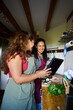 © Alvaro Lavin/Stocksy - Friends cooking healthy recipe together looking at digital tablet
