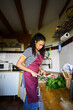 © Alvaro Lavin/Stocksy - Woman cooking fresh vegetables for healthy meal