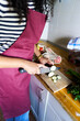 © Alvaro Lavin/Stocksy - Woman cooking fresh zucchini in home kitchen