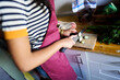© Alvaro Lavin/Stocksy - Woman slicing zucchini in kitchen preparing healthy meal