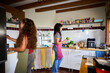 © Alvaro Lavin/Stocksy - Women preparing fresh food in rustic kitchen