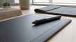 © Mulazimhussain - Digital graphics tablet with stylus pen on wooden desk for creative