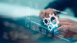 © FAMILY STOCK - Close up hands of programmer typing laptop for software updates process with gear icon, binary code and digital virtual interface for business information technology development system concept.