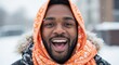 © Network Stock - Close-up portrait of a happy man in an orange winter scarf outdoors