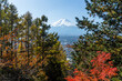 © leungchopan - Mount Fuji view framed by autumn trees under clear blue sky 