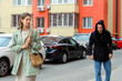 © Pixel-Shot - Personal safety and street harassment, woman feeling anxious while being followed by a suspicious man in a hoodie on a city street