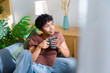 © Metadancer - Young African American woman relaxing with coffee
