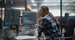 © Gorodenkoff - South Asian Female Software Engineer Wearing Glasses Working Using a Computer With Dual Screens Showing Software Scripts and an Open Laptop at a Workstation in a Bright Modern Startup It Office