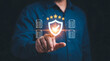 © animonday - Businessman touching digital screen with a shield and five star rating symbol for quality assurance