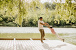 © BGStock72 - Joyful moments of a father swinging his child by the water's edge