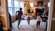 © BlackBridge Media - Excited Children Running Towards Decorated Tree on Christmas Morning
