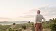 © BlackBridge Media - Senior Man Overlooking Rolling Vineyard Landscape at Sunrise