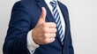 © MdTaher - Businessman wearing suit jacket showing thumbs up sign with agreement approval professional clothing positive expression