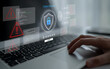 © InfiniteFlow - A person interacts with a laptop displaying cyber security graphics, highlighting alerts and threats. This image emphasizes the importance of online safety in a digital world. Ledger