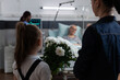© DC Studio - Flowers, child and visit as a young visitor carries a large white bouquet toward an older hospital patient in bed, for recovery support, affection, encouragement, companionship and thoughtful gifting.