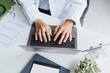© Charlie's - Doctor Using Laptop at Office Desk for Digital Healthcare Management and Modern Medical Services.