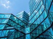 © Chullu Hub - Modern glass architecture facade featuring geometric triangular panels reflecting clear blue sky during bright daylight