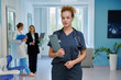© Valerii Honcharuk - Female doctor in scrubs holding clipboard in modern hospital portrait