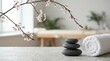 © Robert - Peaceful zen wellness setting with smooth basalt massage stones delicate blooming sakura branches soft rolled fabric towel minimal monochrome concept for relaxation therapy and harmony banner