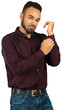 © fotofabrika - Man adjusting his shirt cuff while posing for a picture in a studio setting with a plain background