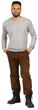 © fotofabrika - Man stands confidently in a gray sweater and brown pants with black boots in a casual setting indoors