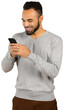 © fotofabrika - Man smiles while using a smartphone in a casual setting, showing engagement with the device