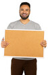 © fotofabrika - Man holds a blank cork board with a smile in a neutral setting while wearing a gray shirt