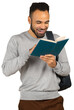 © fotofabrika - Man reading a book and smiling while holding it with a backpack on his shoulder