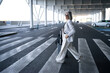 © Metadancer - White woman walking with luggage on urban pedestrian crossing