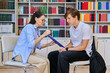 © Valerii Honcharuk - Female psychologist taking notes while consulting teenage student in library