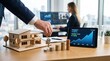 © XXia - Businessman hand holding house keys over wooden model home and stacks of coins, with tablet showing property value growth chart and ROI statistics in modern office