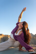 © Ruben - Young Woman Practicing Yoga Stretch Outdoors in Nature at Sunset