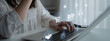 © InfiniteFlow - Businesswoman Working on Laptop with Virtual Icons in Office Environment for Procurement and Request for Proposal Concept. Glyphic.