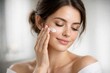 © Rawpixel.com - Woman applying facial cream gently.